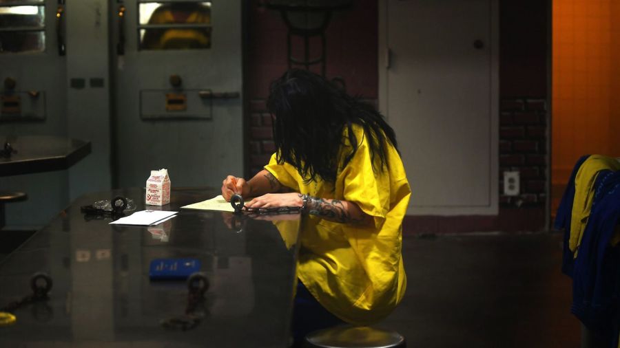 A inmate is seen writing at the Century Regional Detention Facility in Los Angeles in 2017. The jail has been the site of multiple alleged sexual assaults by L.A. County Sheriff's Deputy Giancarlo Scotti, who was arrested in 2017. (Credit: Christina House / Los Angeles Times)