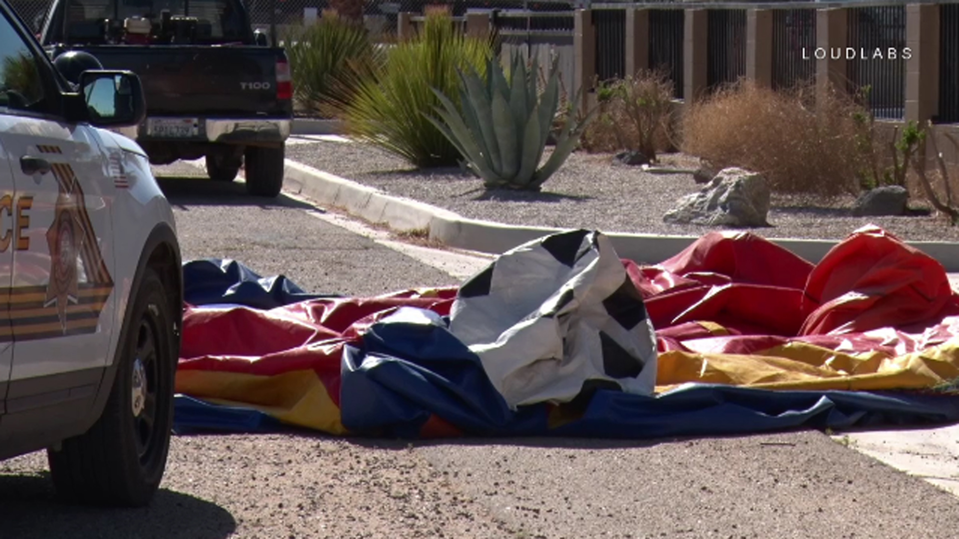 A deflated bounce house sits on the side of a roadway in Victorville after being blown by strong winds onto Highway 395 with a 9-year-old child inside on May 12, 2018. The child was left with minor injuries. (Credit: Loudlabs)