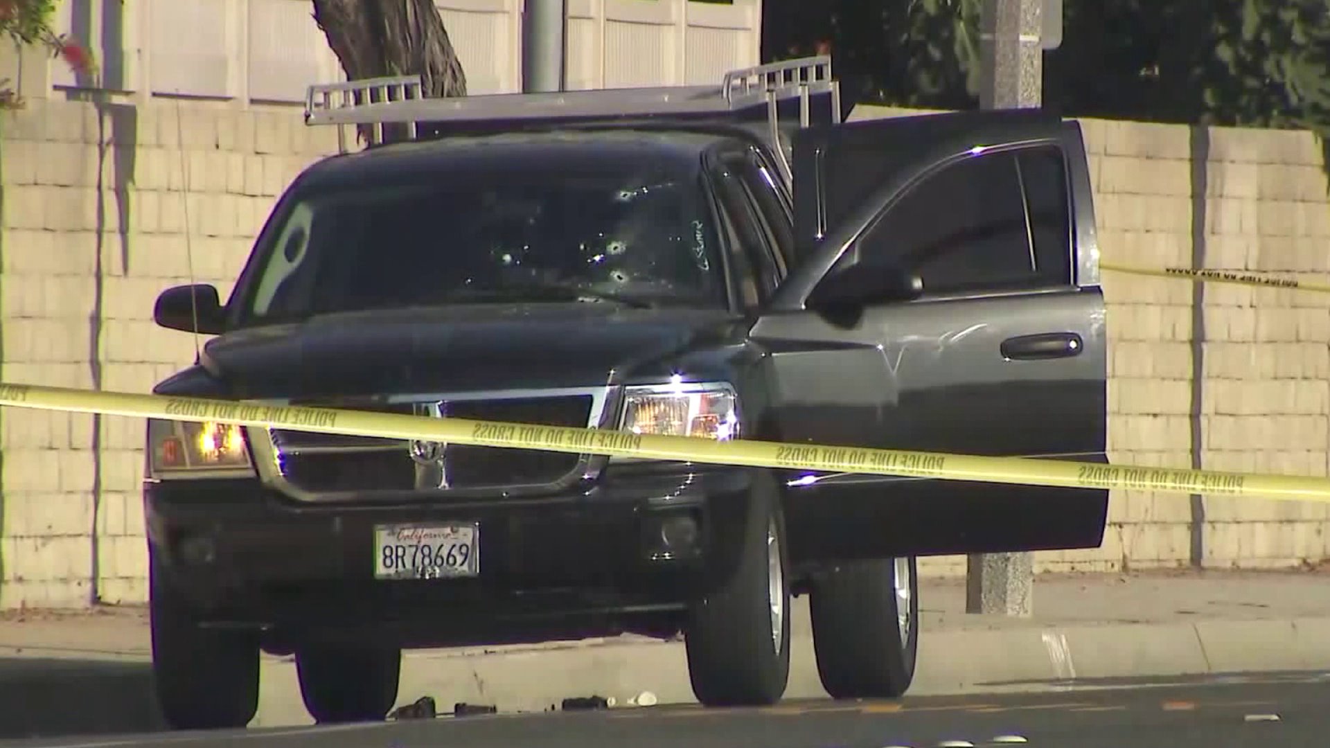 Bullet holes from police gunfire are seen in the windshield of a pickup whose driver allegedly tried to run over two Fountain Valley officers on Oct. 14, 2017. (Credit: OC Hawk)