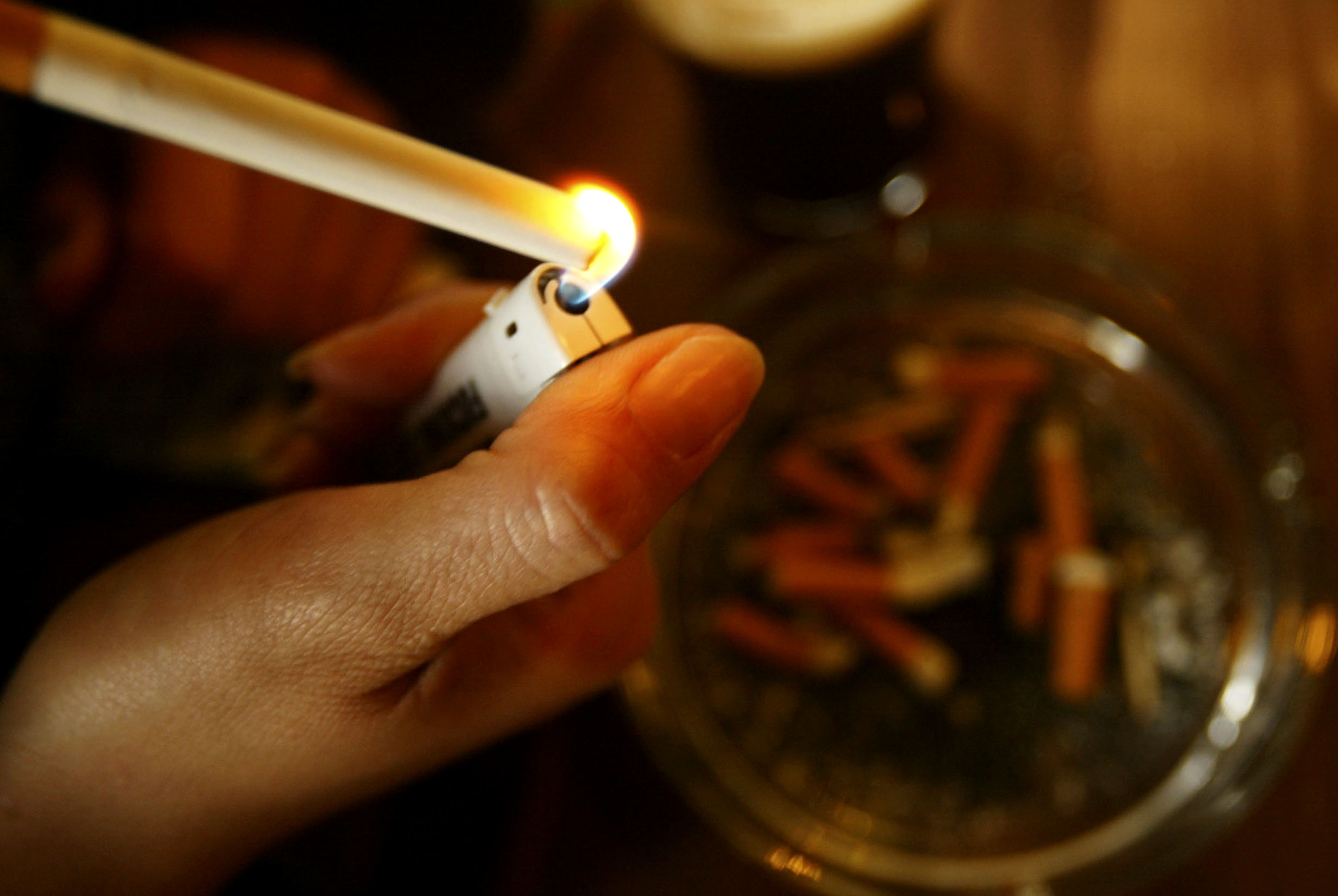 A girl lights up a cigarette in this file photo taken on January 9, 2004. (Credit: Graeme Robertson/Getty Images)