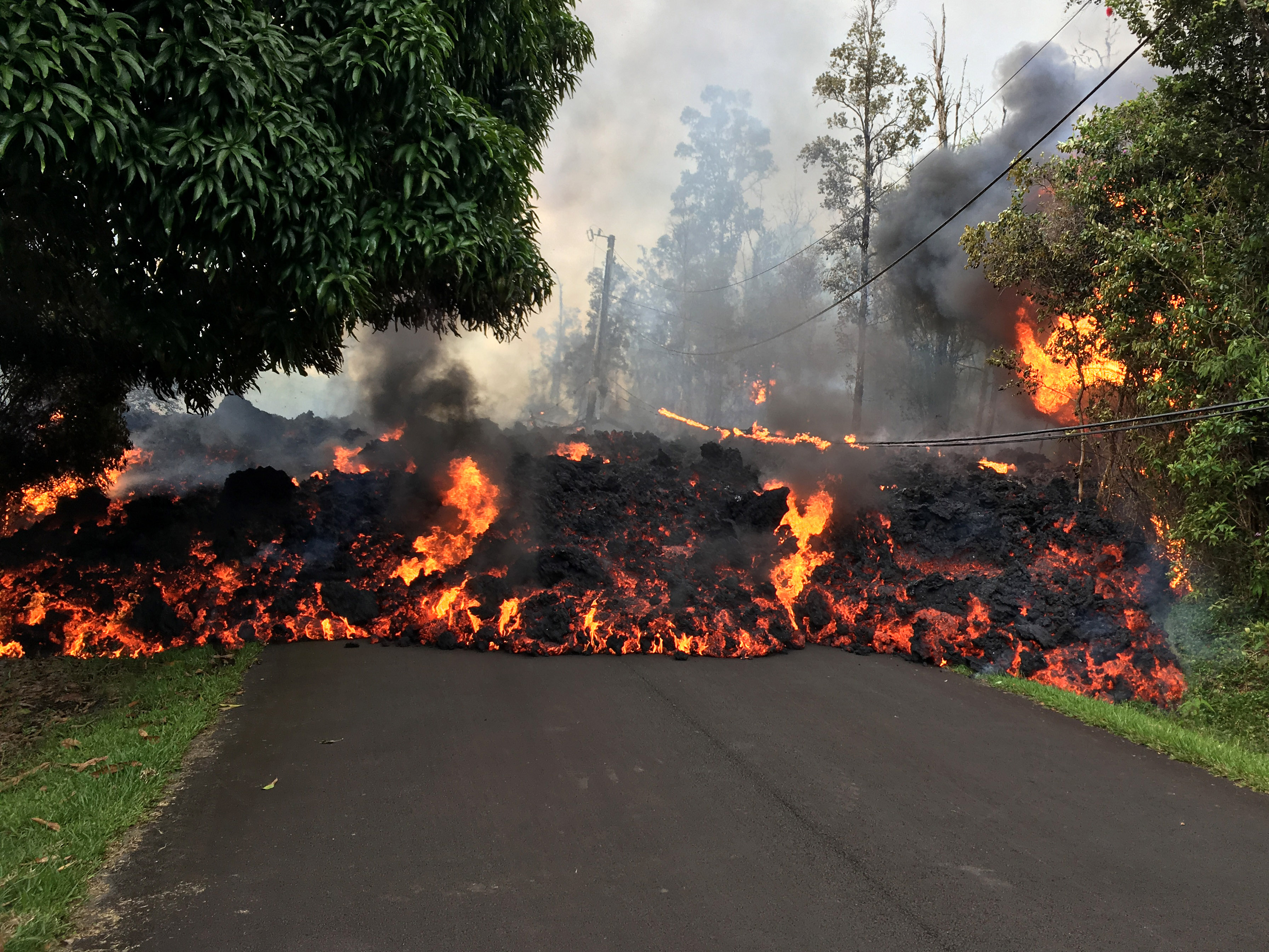 In this handout photo provided by the U.S. Geological Survey, a lava flow moves on Makamae Street after the eruption of Hawaii's Kilauea volcano on May 6, 2018 in the Leilani Estates subdivision near Pahoa, Hawaii. (Credit: U.S. Geological Survey via Getty Images)