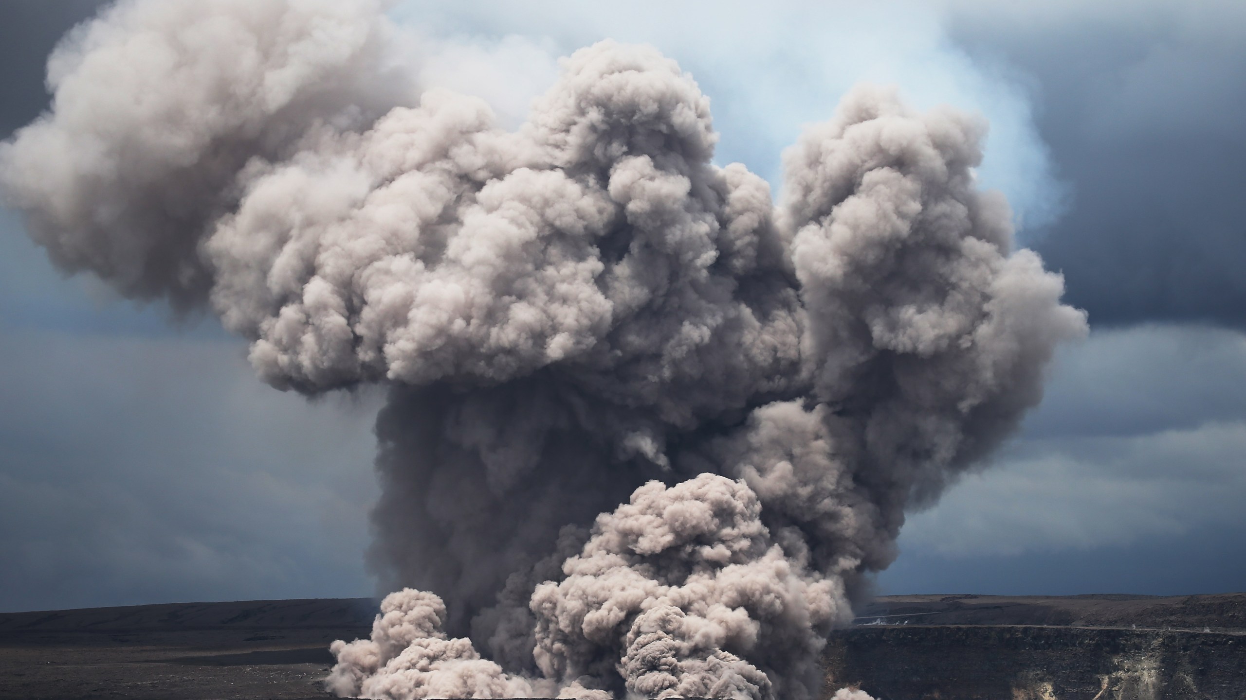 An ash plume rises from the Halemaumau crater within the Kilauea volcano summit caldera at the Hawaii Volcanoes National Park on May 9, 2018. (Credit: Mario Tama / Getty Images)