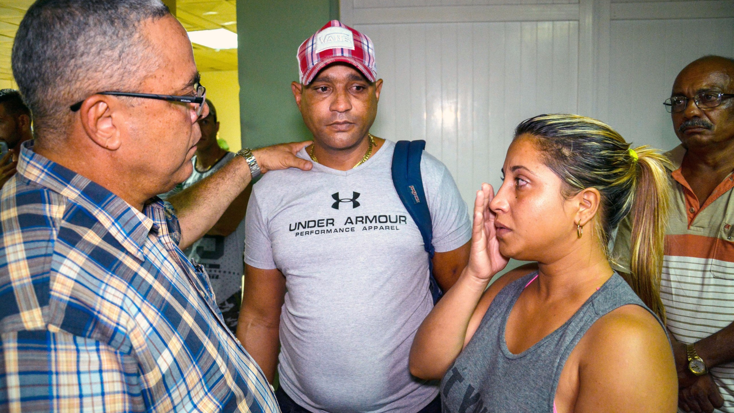 The first secretary of Communist Party in the Cuban city of Holguin, Luis Antonio Torres Iribar (left), speaks with relatives of the victims of a plane crash, at Holguin Airport, after a Cubana de Aviacion aircraft crashed after taking off from Havana's Jose Marti International Airport on May 18, 2018. (Credit: STR/AFP/Getty Images)