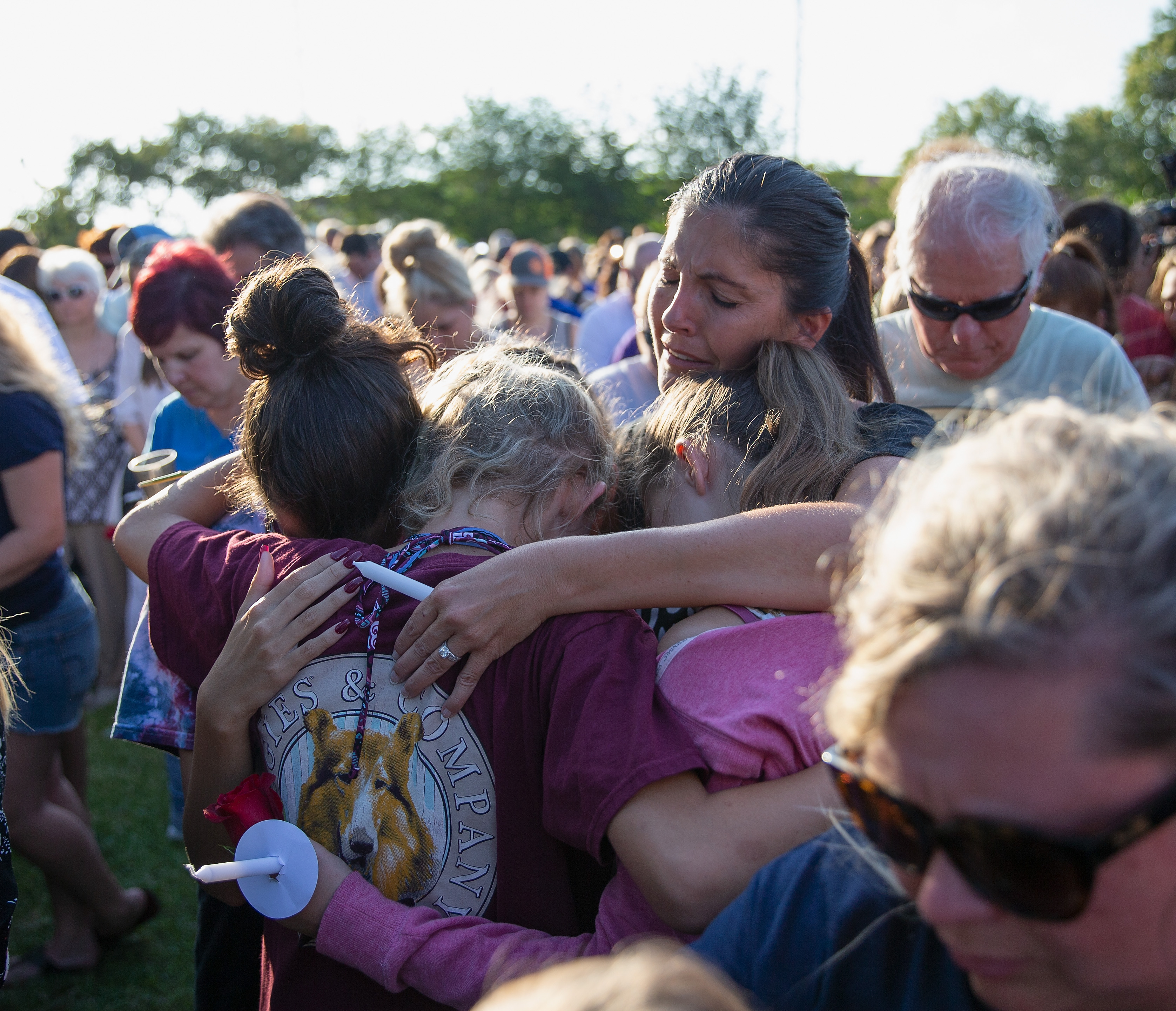 Friends and family attend a vigil held at the First Bank in Santa Fe for the victims of a shooting incident at Santa Fe High School, where a shooter killed at least 10 students on May 18, 2018, in Santa Fe, Texas. (Credit: Bob Levey / Getty Images)