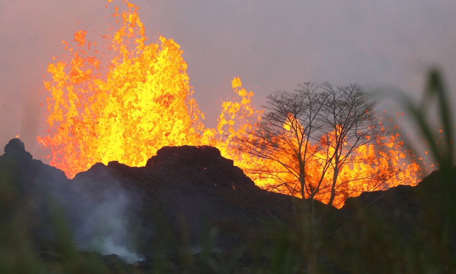 Lava from a Kilauea volcano fissure erupts on Hawaii's Big Island on May 20, 2018 in Kapoho, Hawaii. (Credit: Mario Tama/Getty Images)