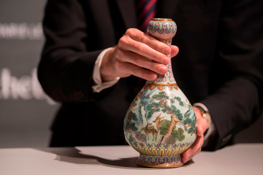 A rare Imperial Qianlong porcelain vase is displayed at Sotheby's auction company in Paris, on May 22, 2018. The vase, which was stored in a shoebox in an attic for decades, will be sold at Sotheby's Paris on June. (Credit: THOMAS SAMSON/AFP/Getty Images)