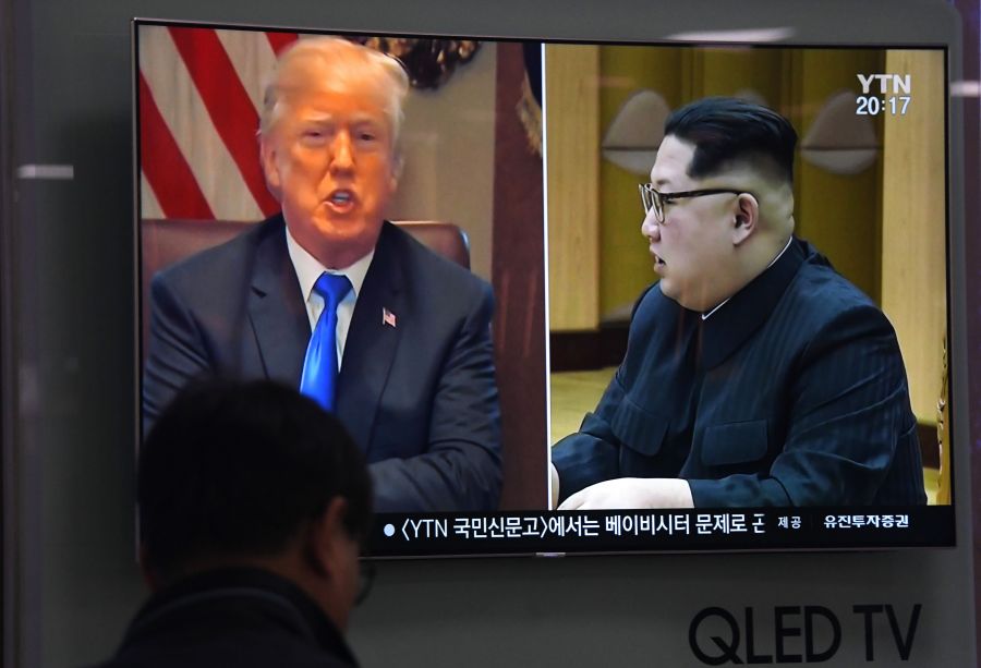 A man watches a television news showing North Korean leader Kim Jong Un and Donald Trump at a railway station in Seoul on May 24, 2018. (Credit: Jung Yeon-Je/AFP/Getty Images)