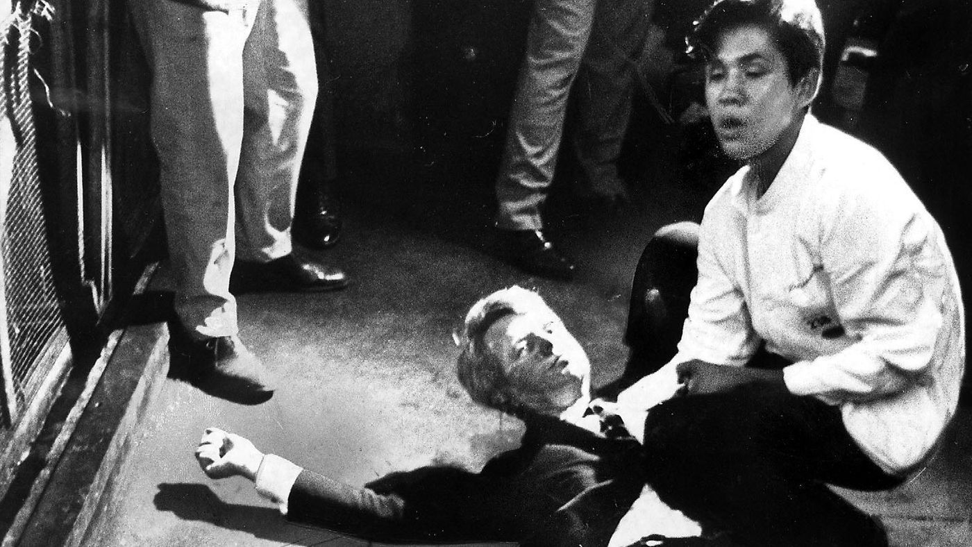 A busboy named Juan Romero crouches over presidential candidate Robert F. Kennedy after the then-senator was fatally shot in Los Angeles just after delivering a victory speech for winning the California Democratic primary on June 5, 1968. (Credit: Boris Yaro / Los Angeles Times)