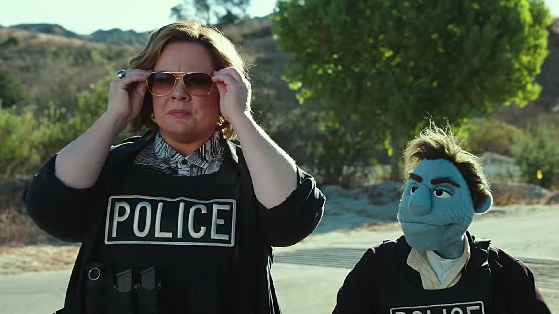 In this undated photo, Melissa McCarthy is seen standing next to her puppet co-star in "The Happytime Murders." (Credit: STX Entertainment via CNN)