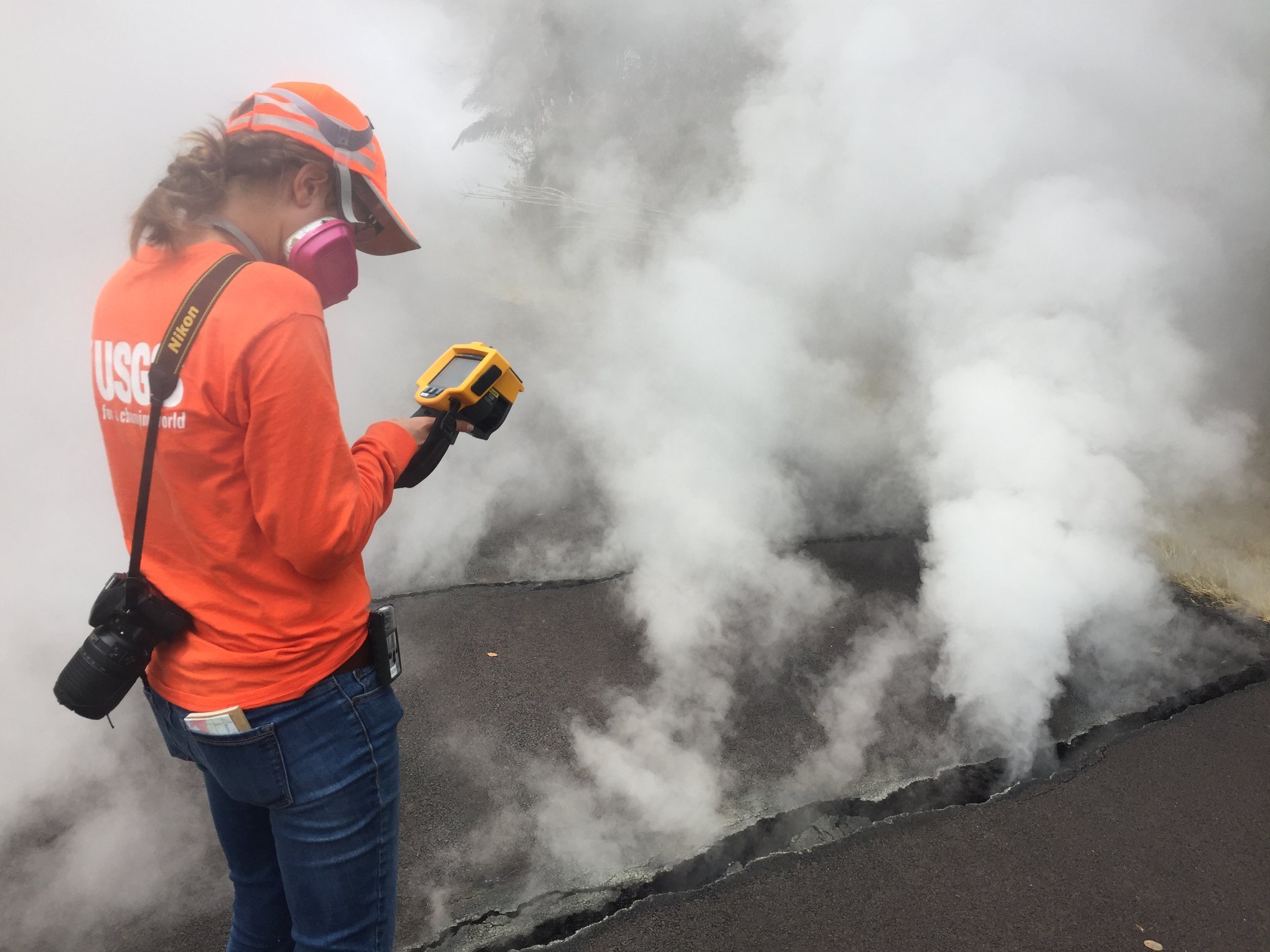 USGS-Hawaiian Volcano Observatory geologist measured a temperature of 103 degrees C (218 degree F) at a crack along Nohea Street, Leilani Estates. The asphalt road was describes as "mushy" from the heat. (Credit: USGS VOLCANOES)