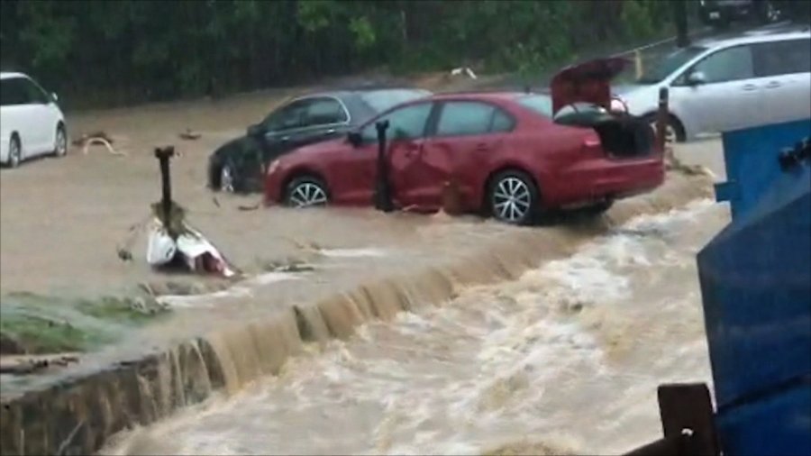 Cars are seen amid flooding in Ellicott City, Maryland on May 28, 2018. (Credit: WBAL via CNN)