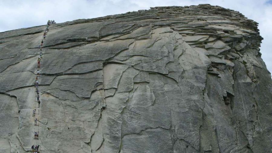 Hikers climb the metal cables on Half Dome in Yosemite National Park in an undated photo. (Credit: Los Angeles Times)