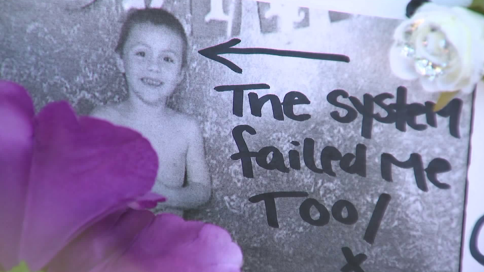 An undated photo of Anthony Avalos with the words "the system failed me too" is displayed at a vigil held to remember him in Lancaster on June 22, 2018. (Credit: KTLA)