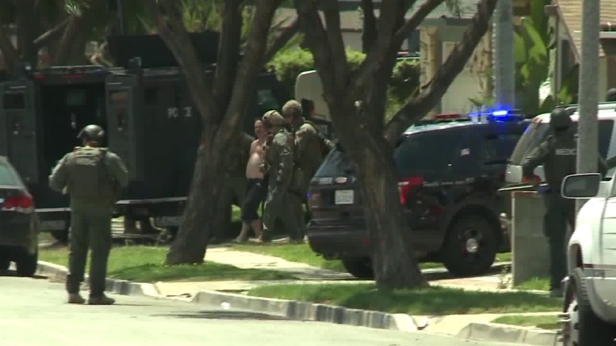 A man is taken into custody following a three-hour standoff with police and SWAT officers in a Brea neighborhood on June 8, 2018. Officers responded after a report of an assault on a 63-year-old woman across the street. (Credit: KTLA)