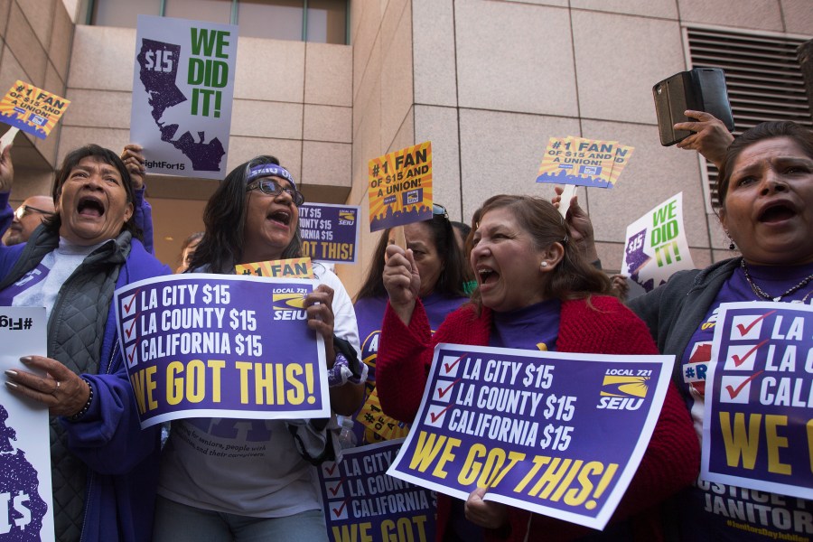 Service Employees International Union members celebrate after Jerry Brown signed landmark legislation SB 3 into law on April 4, 2016 in Los Angeles. (Credit: David McNew/Getty Images)