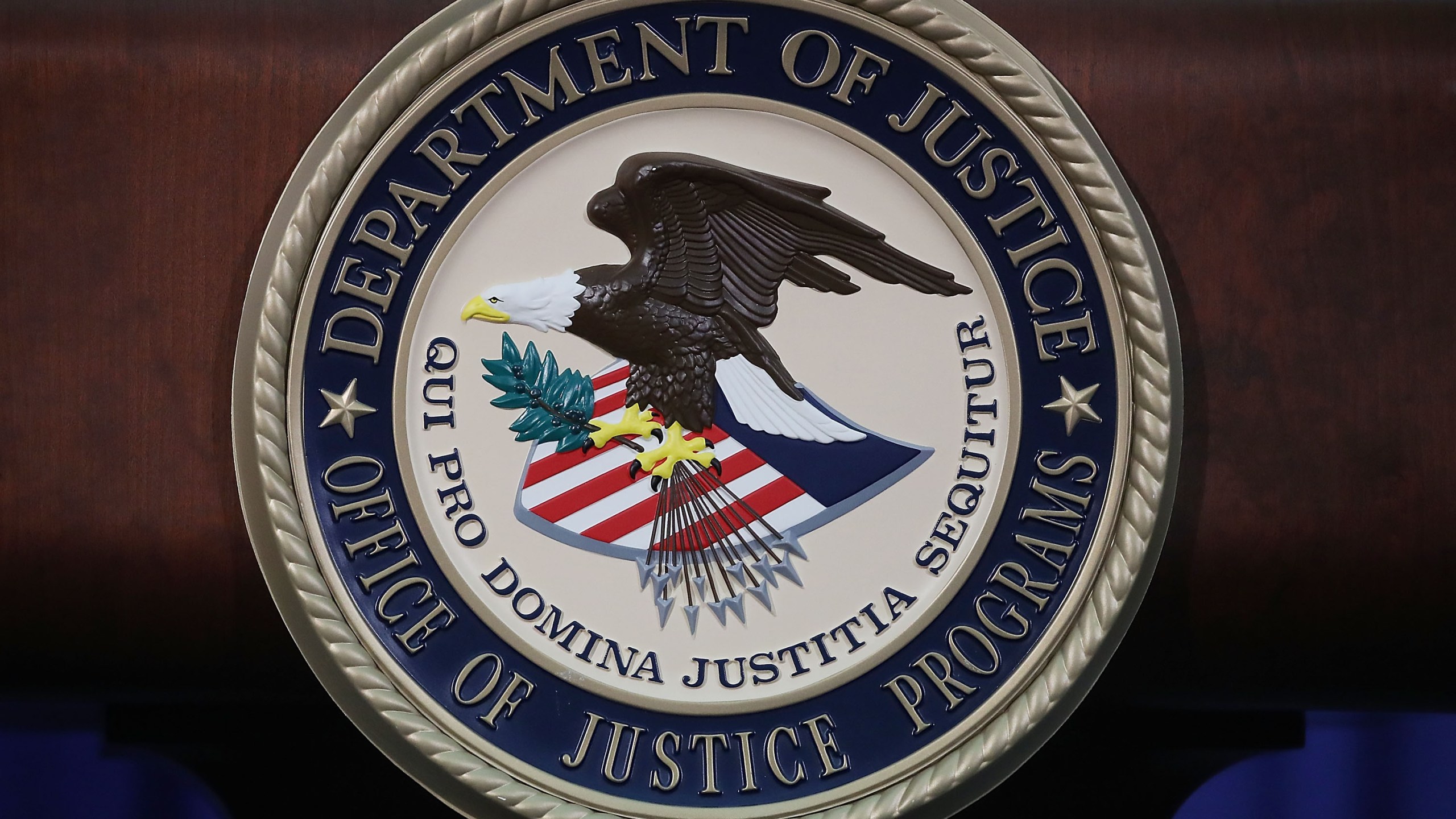 The Justice Department seal is seen on the lectern during a Hate Crimes Subcommittee summit on June 29, 2017 in Washington, D.C. (Credit: Mark Wilson/Getty Images)