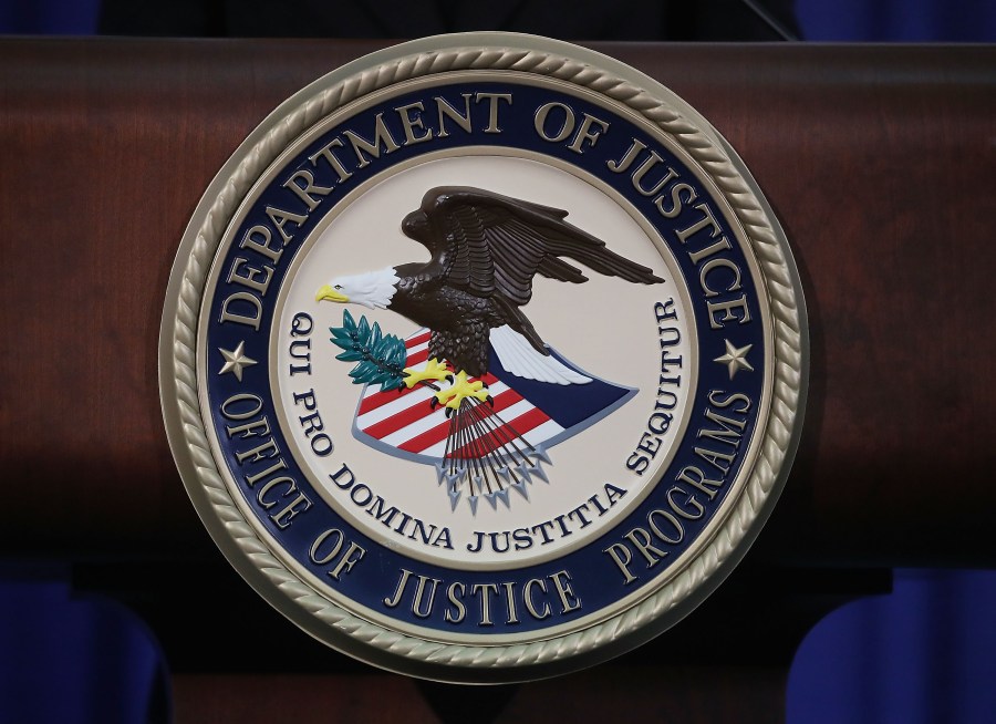 The Justice Department seal is seen on the lectern during a Hate Crimes Subcommittee summit on June 29, 2017 in Washington, D.C. (Credit: Mark Wilson/Getty Images)