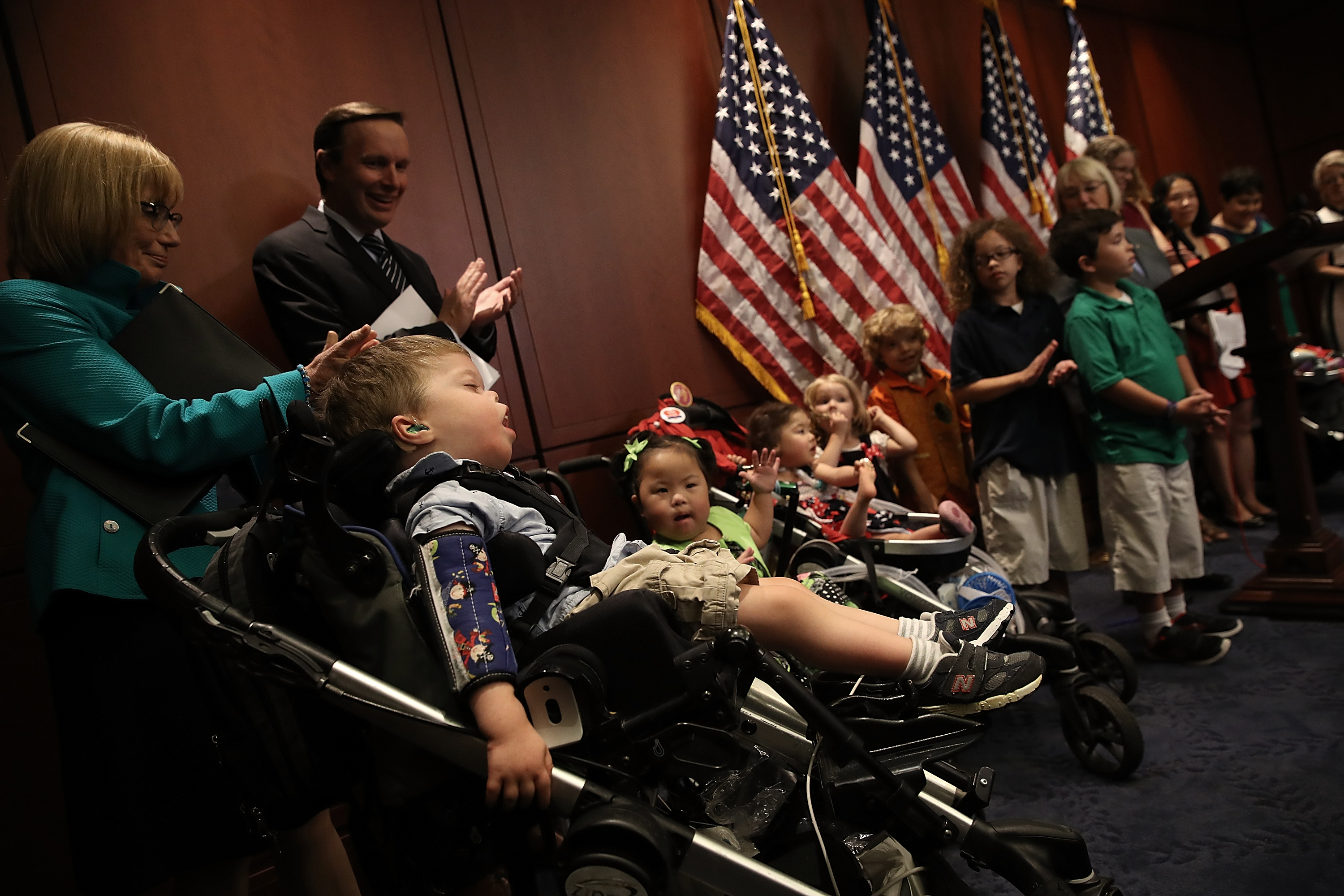 Families attend a press conference held to highlight the effects of a proposal considered by the U.S. Senate in an effort to repeal and replace the Affordable Care Act, which guaranteed coverage to patients with pre-existing conditions, at the U.S. Capitol on July 12, 2017 in Washington D.C. (Credit: Win McNamee/Getty Images)