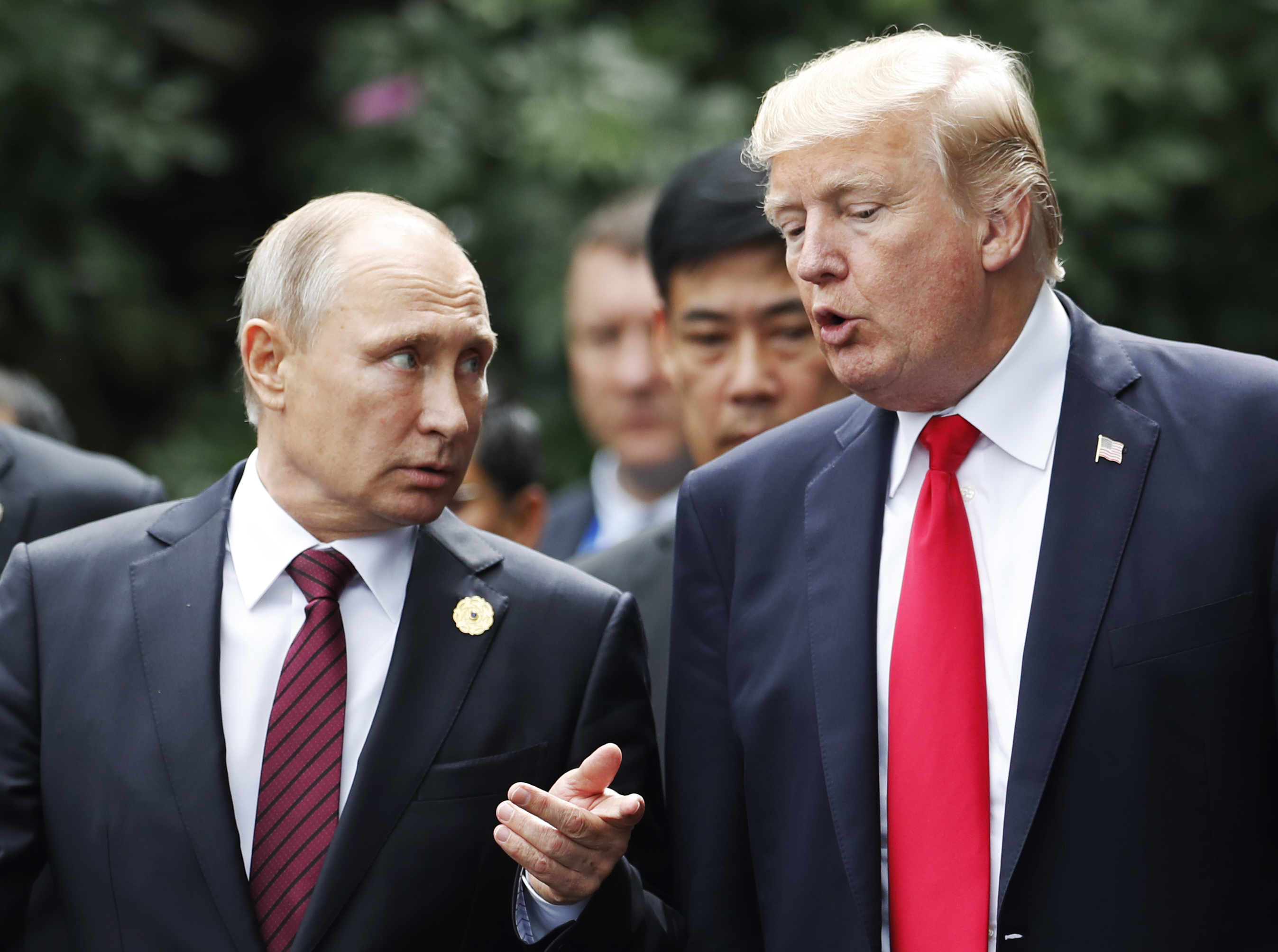 US President Donald Trump (R) and Russia's President Vladimir Putin talk in the central Vietnamese city of Danang on November 11, 2017. (Credit: JORGE SILVA/AFP/Getty Images)