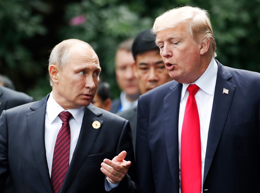 US President Donald Trump (R) and Russia's President Vladimir Putin talk in the central Vietnamese city of Danang on November 11, 2017. (Credit: JORGE SILVA/AFP/Getty Images)