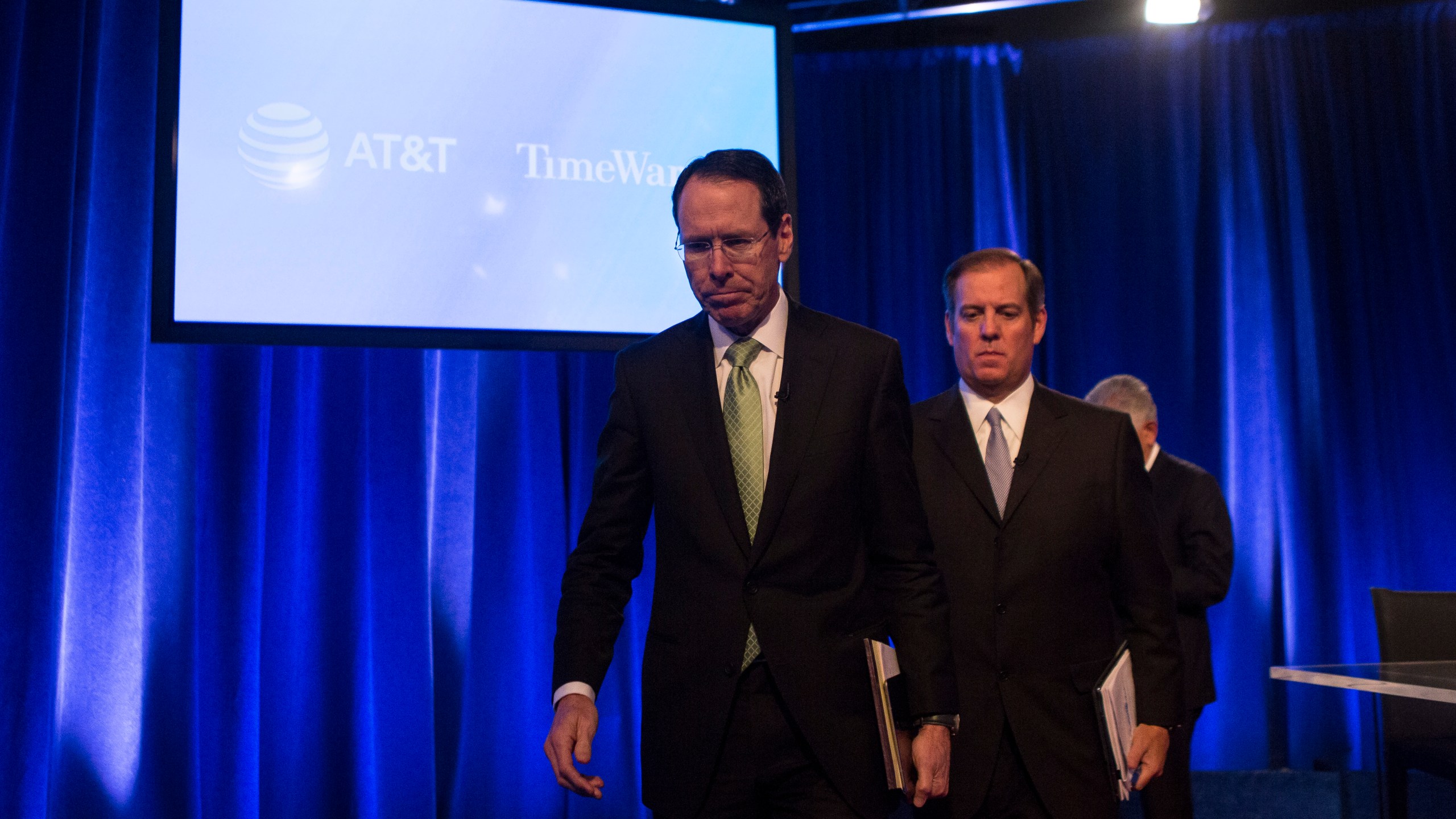 AT&T Chairman and CEO Randall Stephenson and AT&T Senior Executive Vice President David R. McAtee II leave after a news conference in Time Warner headquarters addressing the latest developments in the AT&T and Time Warner merger on Nov. 20, 2017 in New York City. (Credit: Amir Levy/Getty Images)