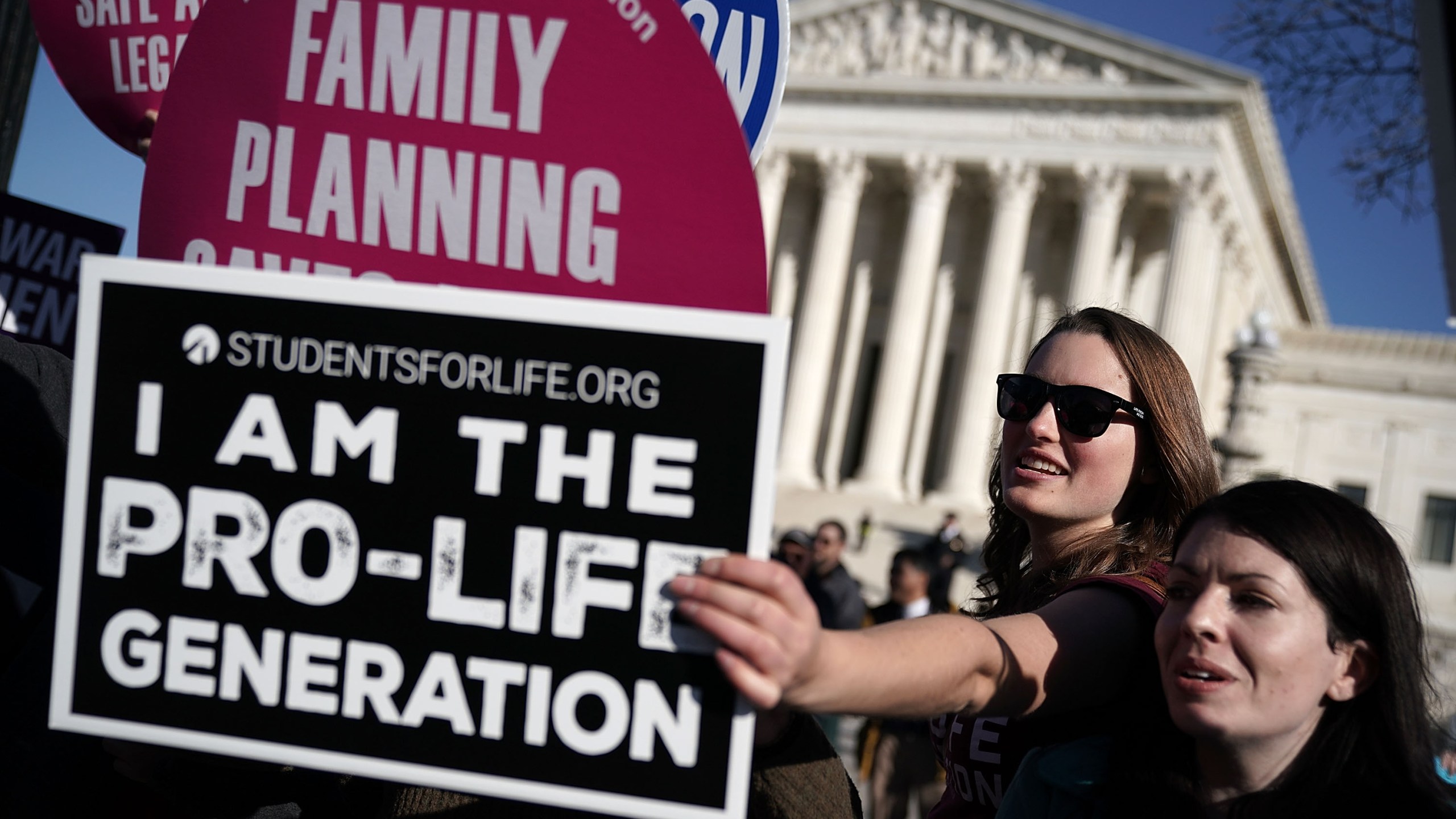 A pro-life activist tries to block the signs of pro-choice activists in front of the the U.S. Supreme Court during the 2018 March for Life January 19, 2018 in Washington, D.C. (Credit: Alex Wong/Getty Images)