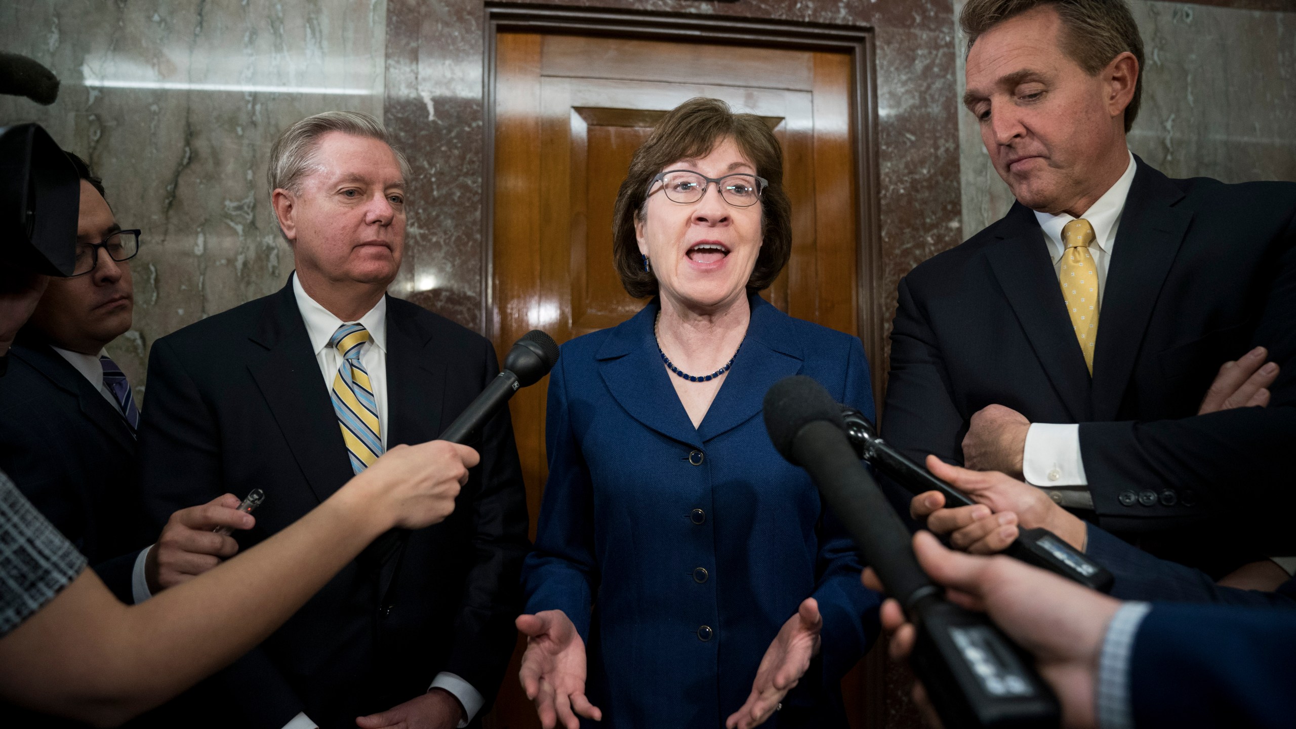 (Left to Right) Sen. Lindsey Graham (R-SC), Sen. Susan Collins (R-ME) and Sen. Jeff Flake (R-AZ) talk to reporters after a meeting with a bipartisan group of moderate Senators on Jan. 22, 2018. (Credit: Drew Angerer/Getty Images)