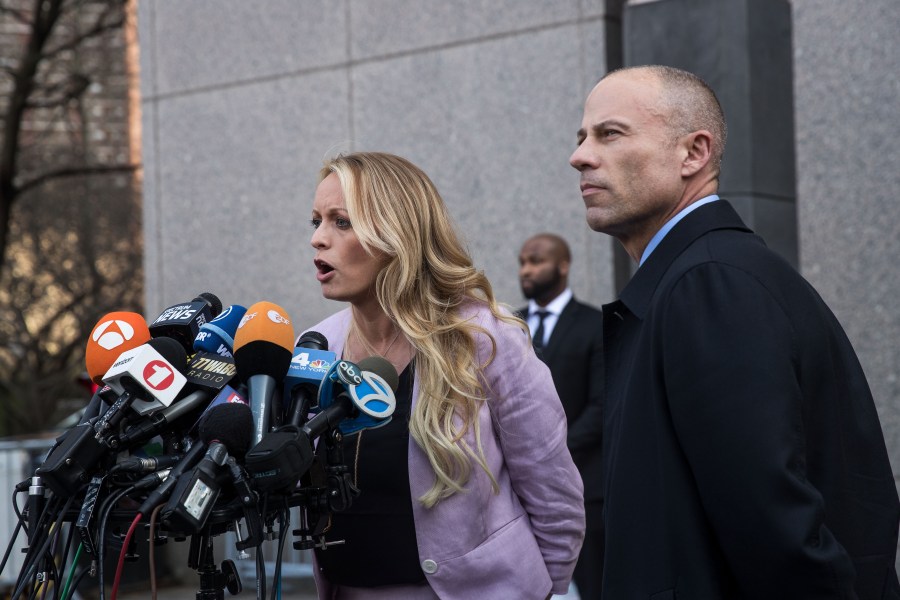 Adult film actress Stormy Daniels, whose legal name is Stephanie Clifford, and Michael Avenatti, her attorney, speak to the media as they exit the United States District Court Southern District of New York for a hearing related to Michael Cohen, President Trump's longtime personal attorney and confidante, on April 16, 2018, in New York City. (Credit: Drew Angerer/Getty Images)