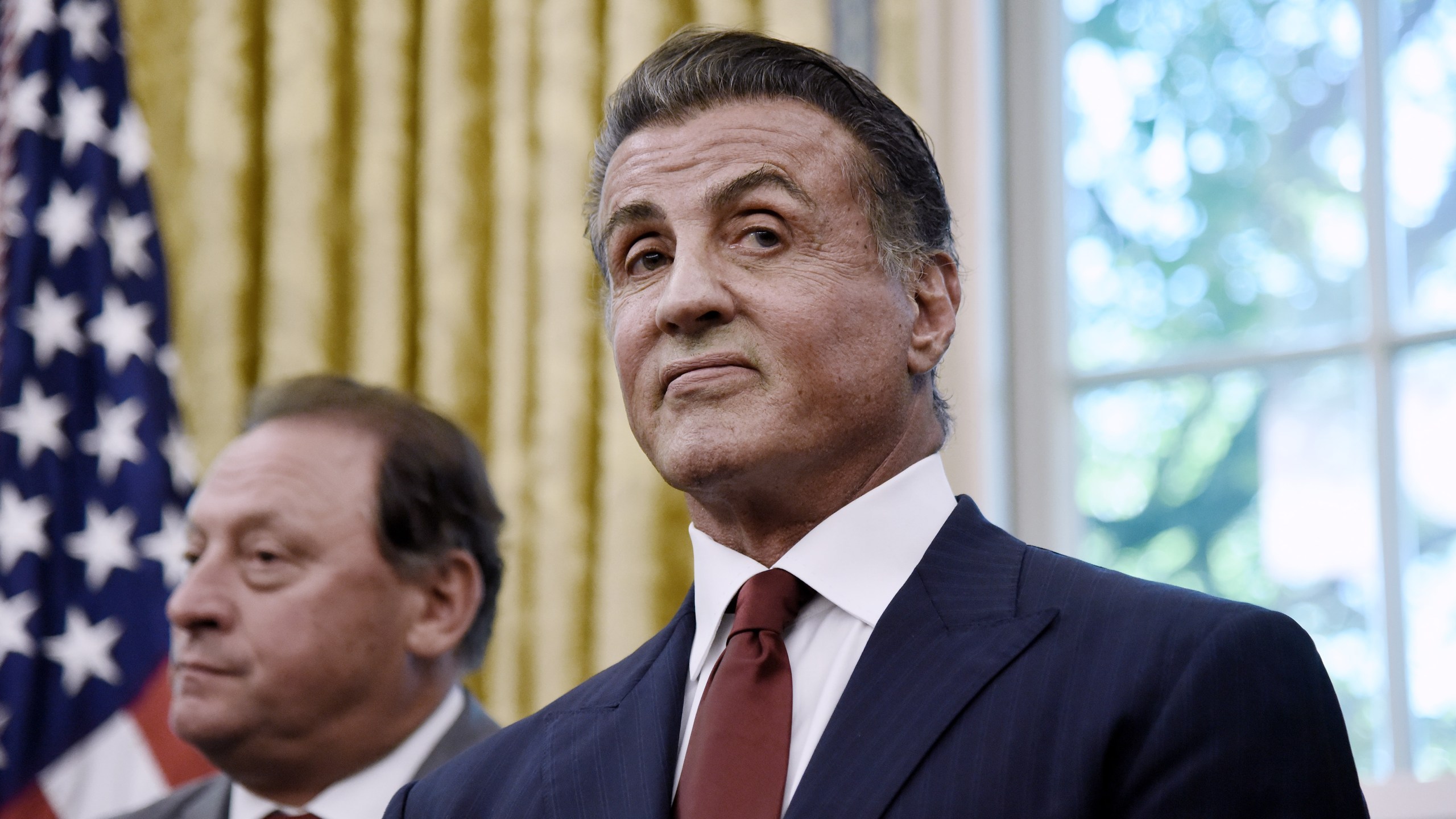 Sylvester Stallone looks on during a signing ceremony to grant of Clemency for former heavyweight champion Jack Johnson in the Oval Office of the White House on May 24, 2018 in Washington, D.C. (Credit: Olivier Douliery-Pool/Getty Images)