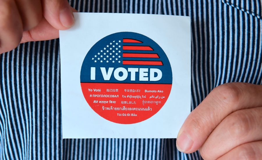 A woman displays a sticker given to voters outside a polling station in Los Angeles on June 5, 2018. (Credit: Frederic J. Brown / AFP / Getty Images)