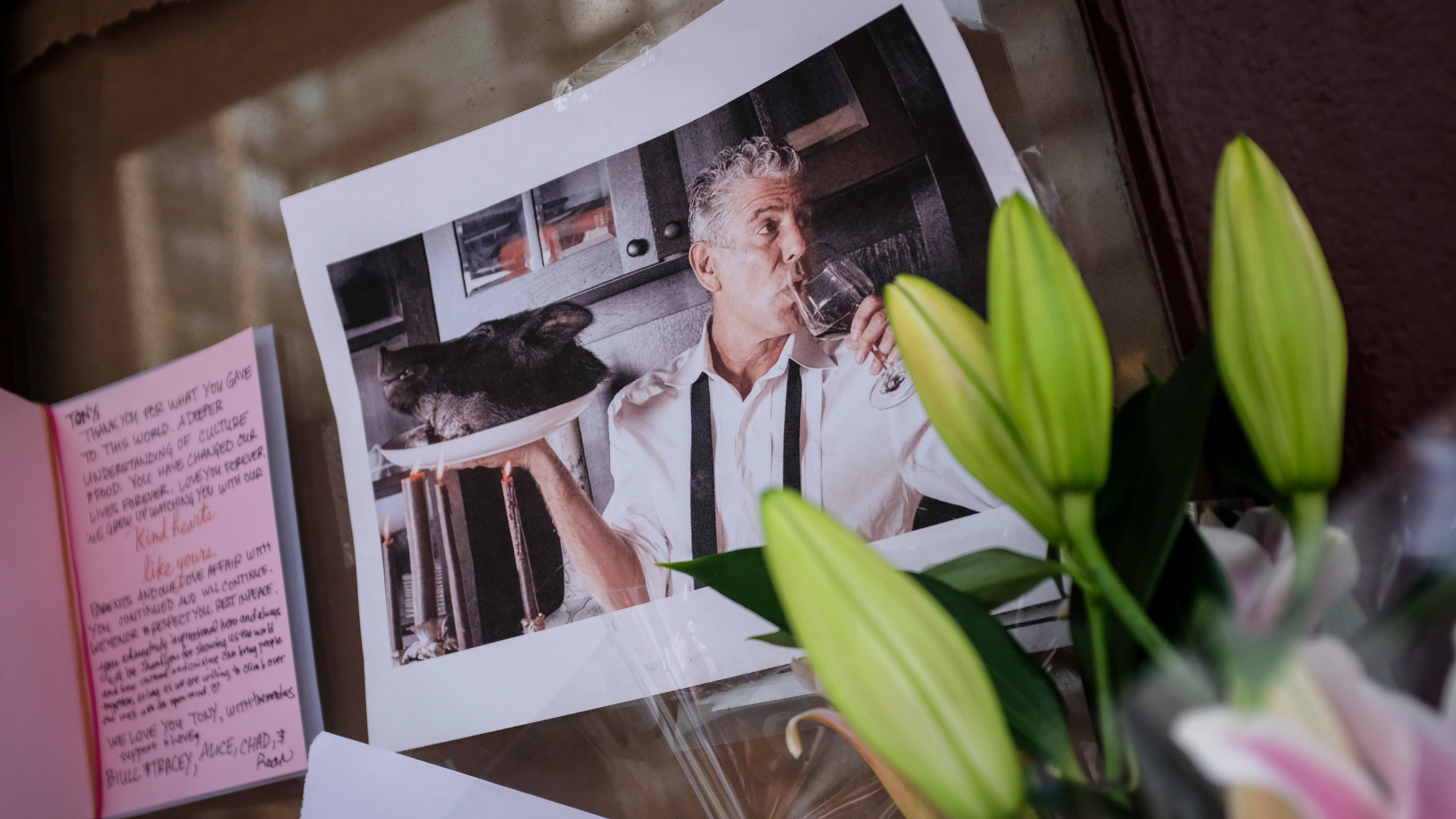 Notes, photographs and flowers are left in memory of Anthony Bourdain at the closed location of Brasserie Les Halles, where Bourdain used to work as the executive chef, June 8, 2018, in New York City. Bourdain, a writer, chef and television personality, was found dead in his hotel room in France earlier in the day.(Credit: Drew Angerer/Getty Images)