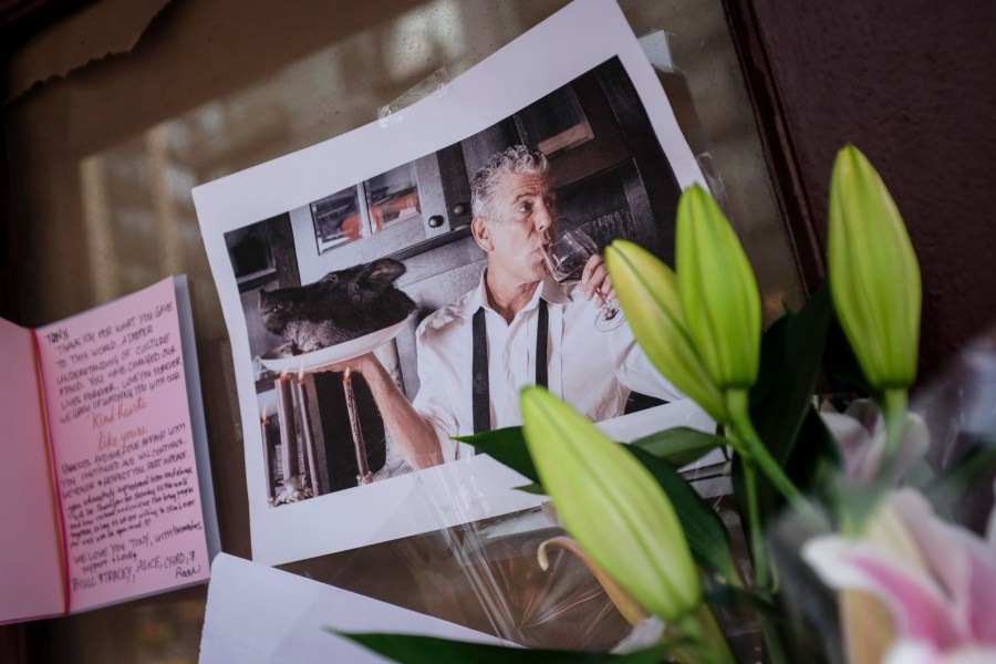 Notes, photographs and flowers are left in memory of Anthony Bourdain at the closed location of Brasserie Les Halles, where Bourdain used to work as the executive chef, June 8, 2018, in New York City. Bourdain, a writer, chef and television personality, was found dead in his hotel room in France earlier in the day.(Credit: Drew Angerer/Getty Images)