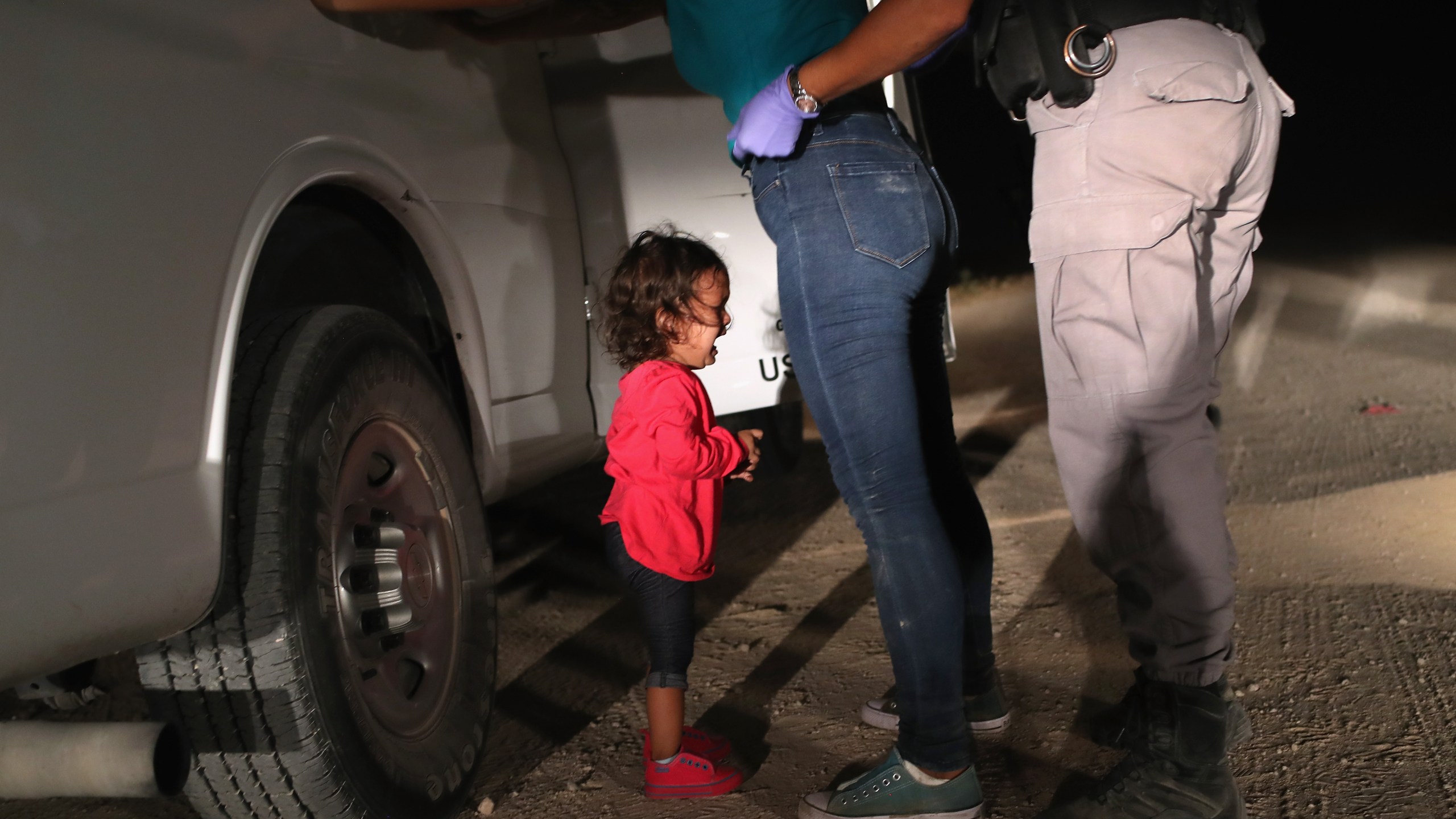 A 2-year-old Honduran asylum seeker cries as her mother is searched and detained near the U.S.-Mexico border on June 12, 2018, in McAllen, Texas. (Credit: John Moore / Getty Images)