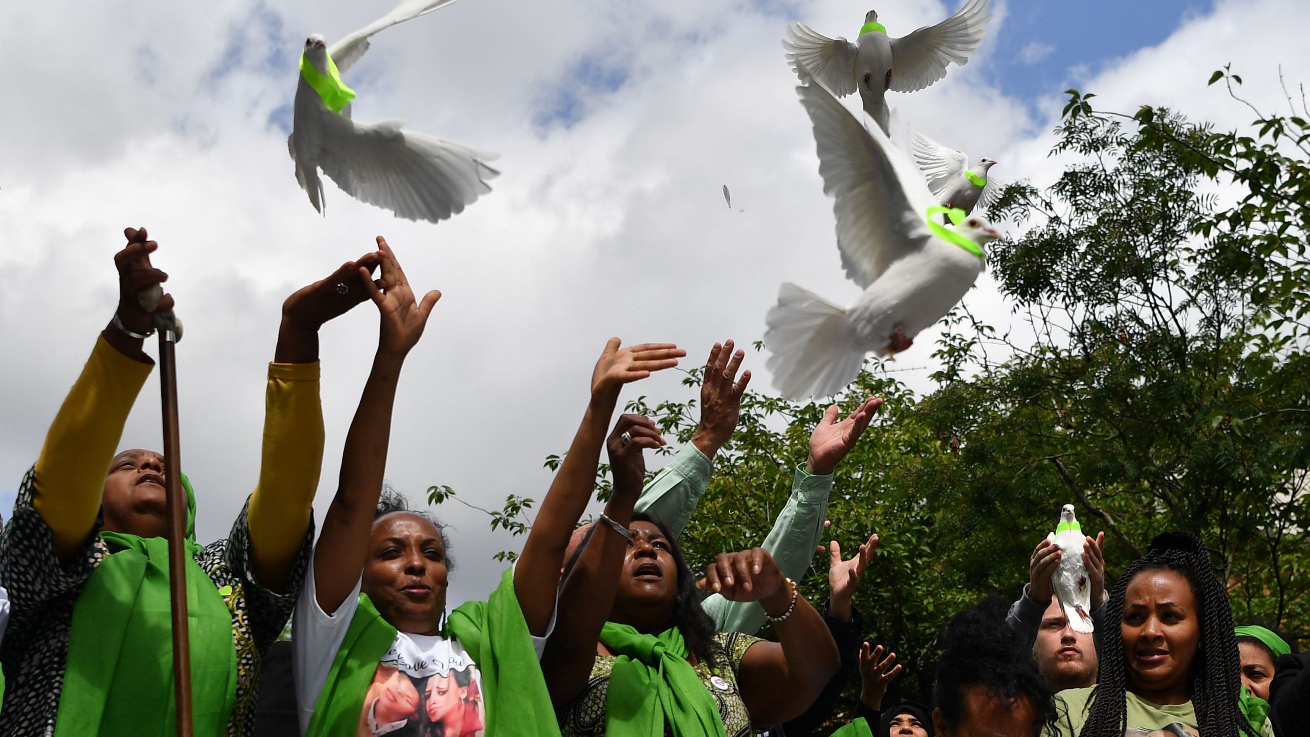 Members of the public release doves outside St Helen's church on June 14, 2018 as part of commemorations on the one year anniversary of the Grenfell fire in west London. (Credit: Ben Stansall/AFP/Getty Images)