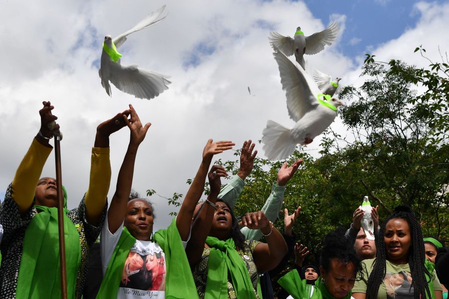 Members of the public release doves outside St Helen's church on June 14, 2018 as part of commemorations on the one year anniversary of the Grenfell fire in west London. (Credit: Ben Stansall/AFP/Getty Images)