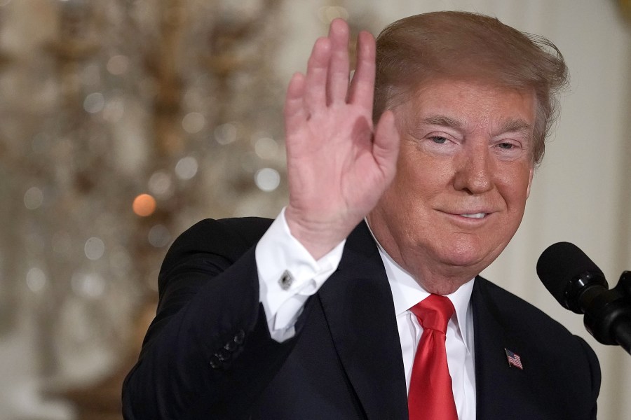 Donald Trump waves during a meeting of the National Space Council at the East Room of the White House on June 18, 2018. (Credit: Alex Wong/Getty Images)