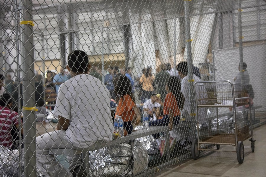 In this handout photo provided by U.S. Customs and Border Protection, U.S. Border Patrol agents conduct intake of immigrants at the Central Processing Center in McAllen, Texas, on June 17, 2018.