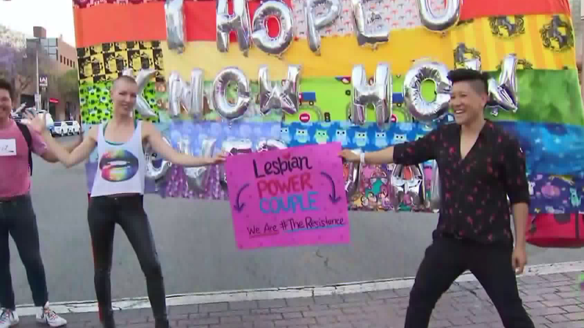 Attendees of the 2018 L.A. Pride Festival hold a sign showing their support for LGBTQ rights in West Hollywood on June 9, 2018. (Credit: KTLA)