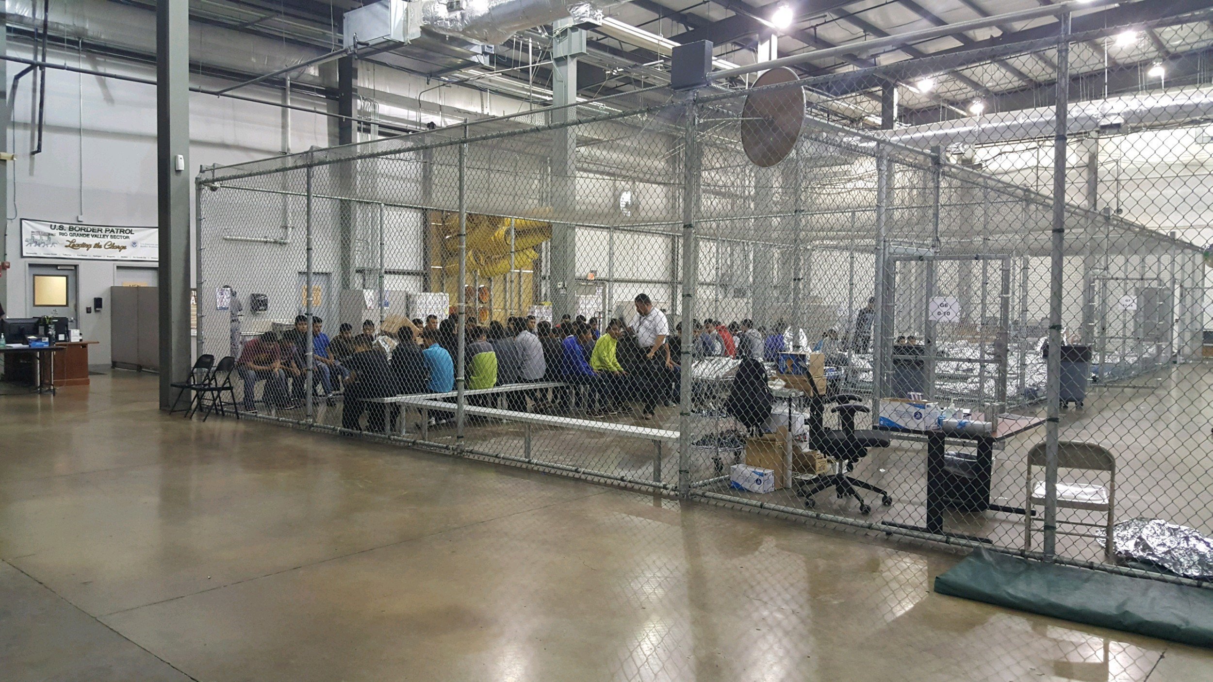 The warehouse-like facility has holding pens made from chain-link fences on the inside separating the immigrants. (Credit: US Customs and Border Patrol)