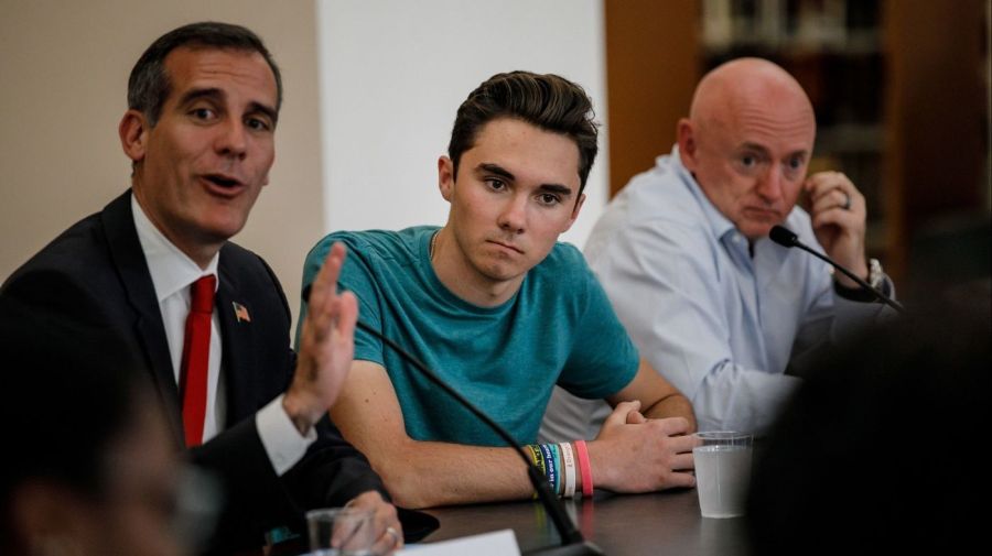 David Hogg, center, listens to Los Angeles Mayor Eric Garcetti, left, during a round table in Los Angeles on July 19, 2018. On the right is retired astronaut and gun-control activist Mark Kelly. (Credit: Marcus Yam / Los Angeles Times)