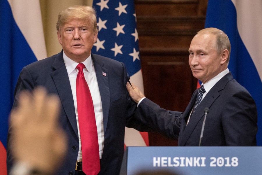 U.S. President Donald Trump, left, and Russian President Vladimir Putin shake hands during a joint press conference after their summit on July 16, 2018, in Helsinki, Finland. (Credit: Chris McGrath/Getty Images)