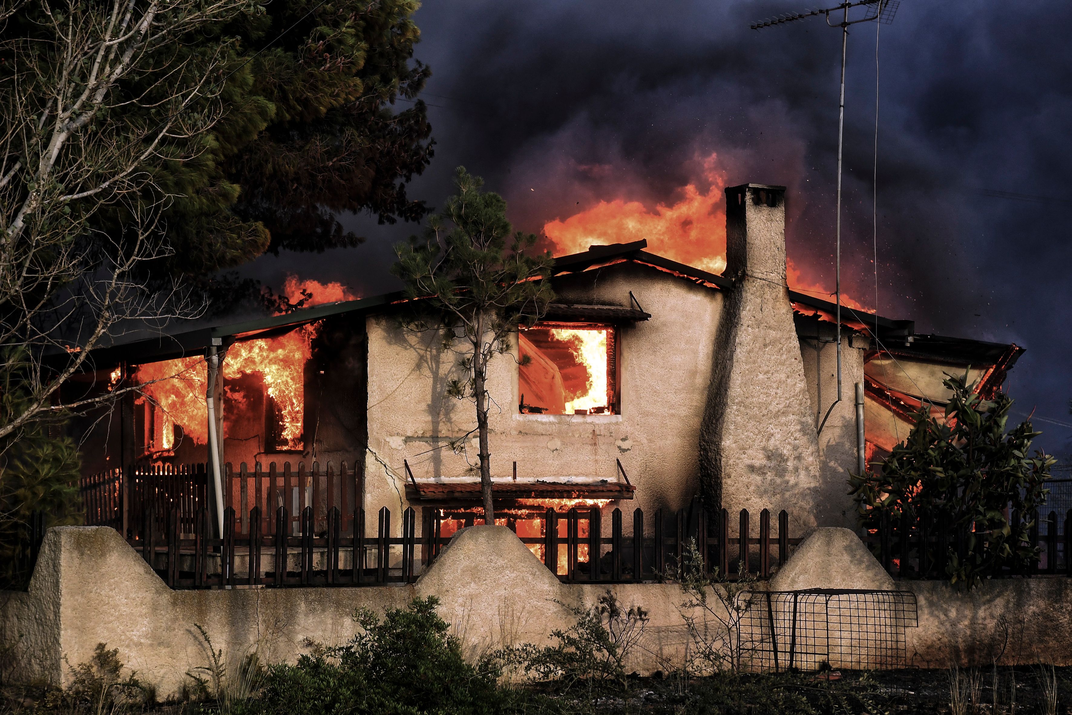 A house burns during a wildfire in Kineta, Greece, near Athens, on July 23, 2018. (Credit: Valerie Gache / AFP / Getty Images)