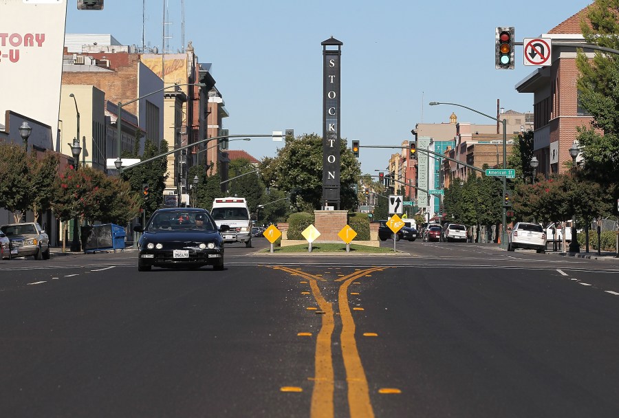 Cars drive by a sign on June 27, 2012, in Stockton, Calif. (Credit: Justin Sullivan/Getty Images)