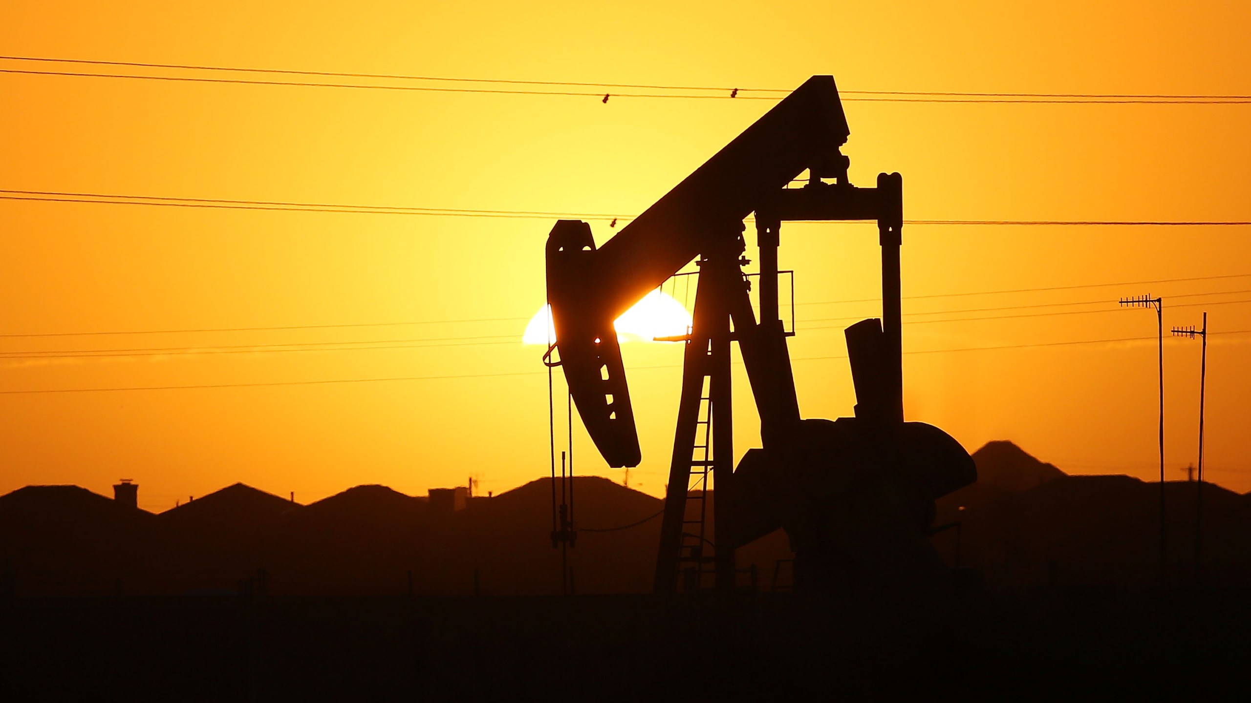 A pump jack sits on the outskirts of town at dawn in the Permian Basin oil field on January 21, 2016 in the oil town of Midland, Texas. (Credit: Spencer Platt/Getty Images)