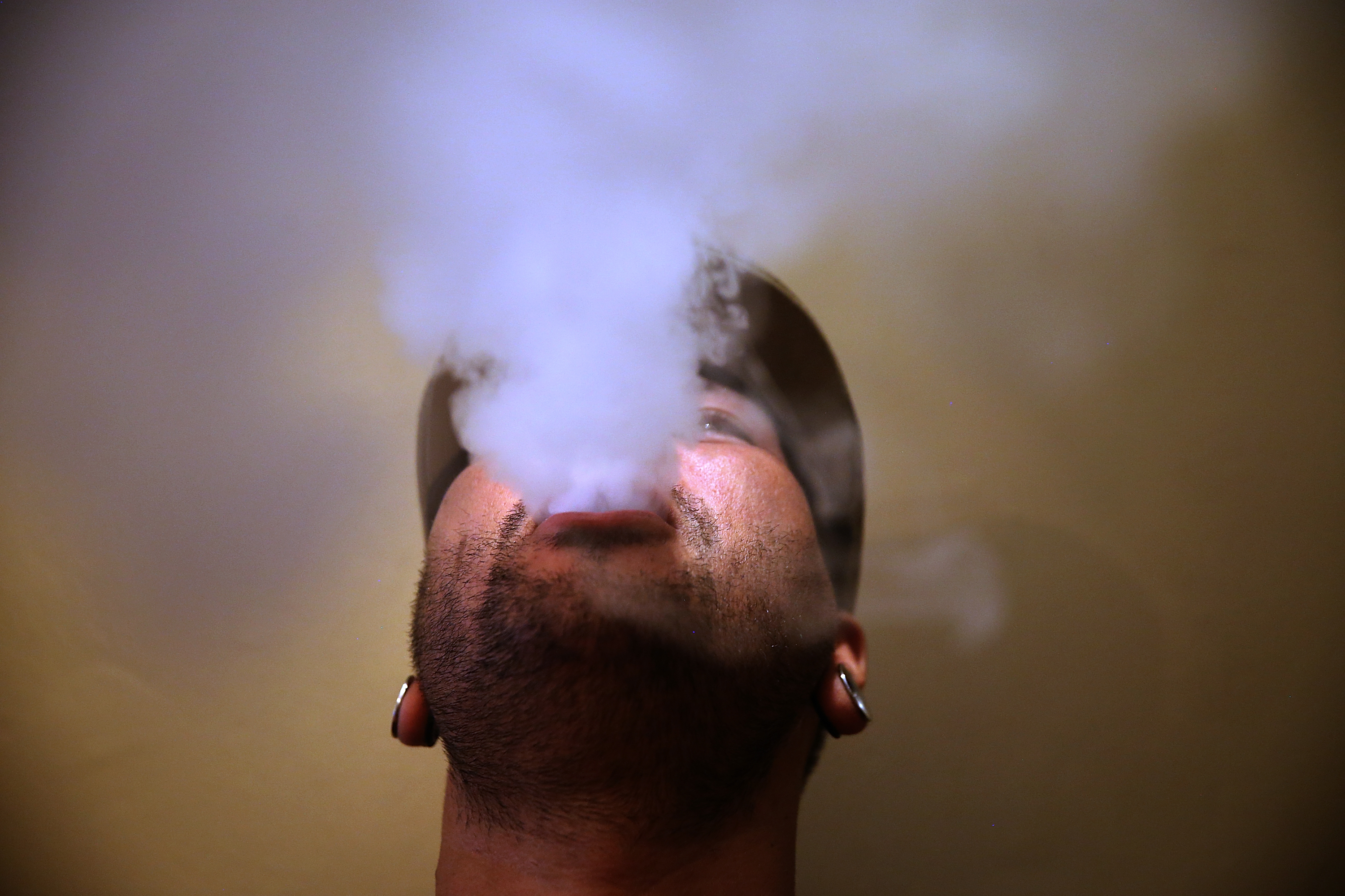 A person blows vapor from an e-cigarette on May 5, 2016 in San Francisco. (Credit: Justin Sullivan/Getty Images)