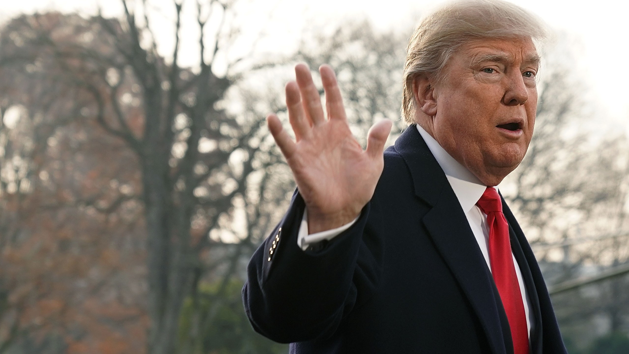 Donald Trump gestures as he speaks to members of the media on former national security adviser Michael Flynn's lying to the FBI prior to his Marine One departure from the South Lawn of the White House Dec. 4, 2017 in Washington, D.C. (Credit: Alex Wong/Getty Images)