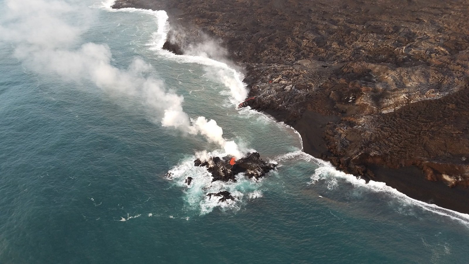 A photo released on July 13, 2018 shows a close view of the new "island," which was estimated to be just a few meters offshore.