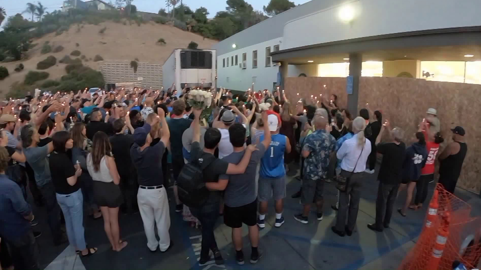 Family and community members gather outside Trader Joe's in Silver Lake on July 24, 2018, for a memorial honoring Melyda Corado, a store employee who was killed in a shootout there. (Credit: KTLA)