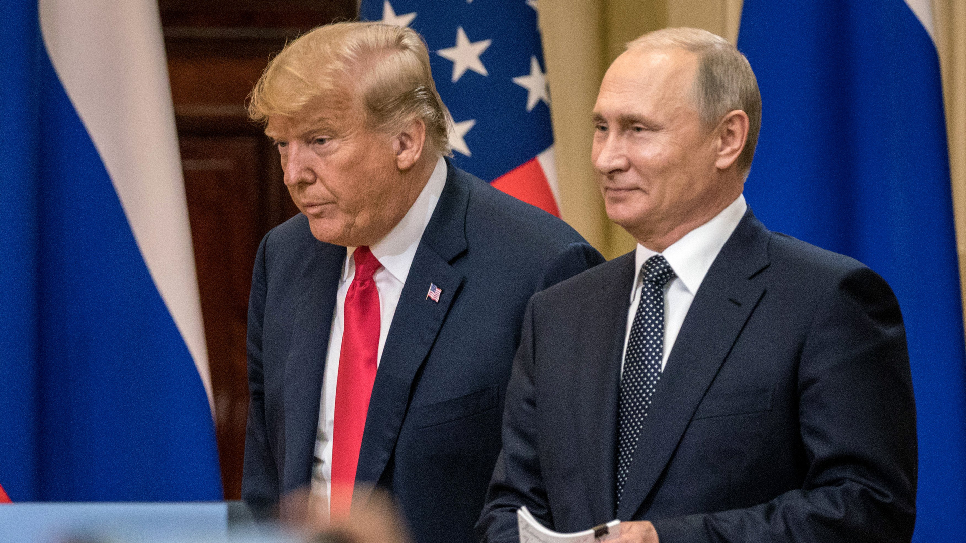 President Donald Trump and Russian President Vladimir Putin arrive to waiting media during a joint press conference after their summit on July 16, 2018, in Helsinki, Finland. (Credit: Chris McGrath/Getty Images)