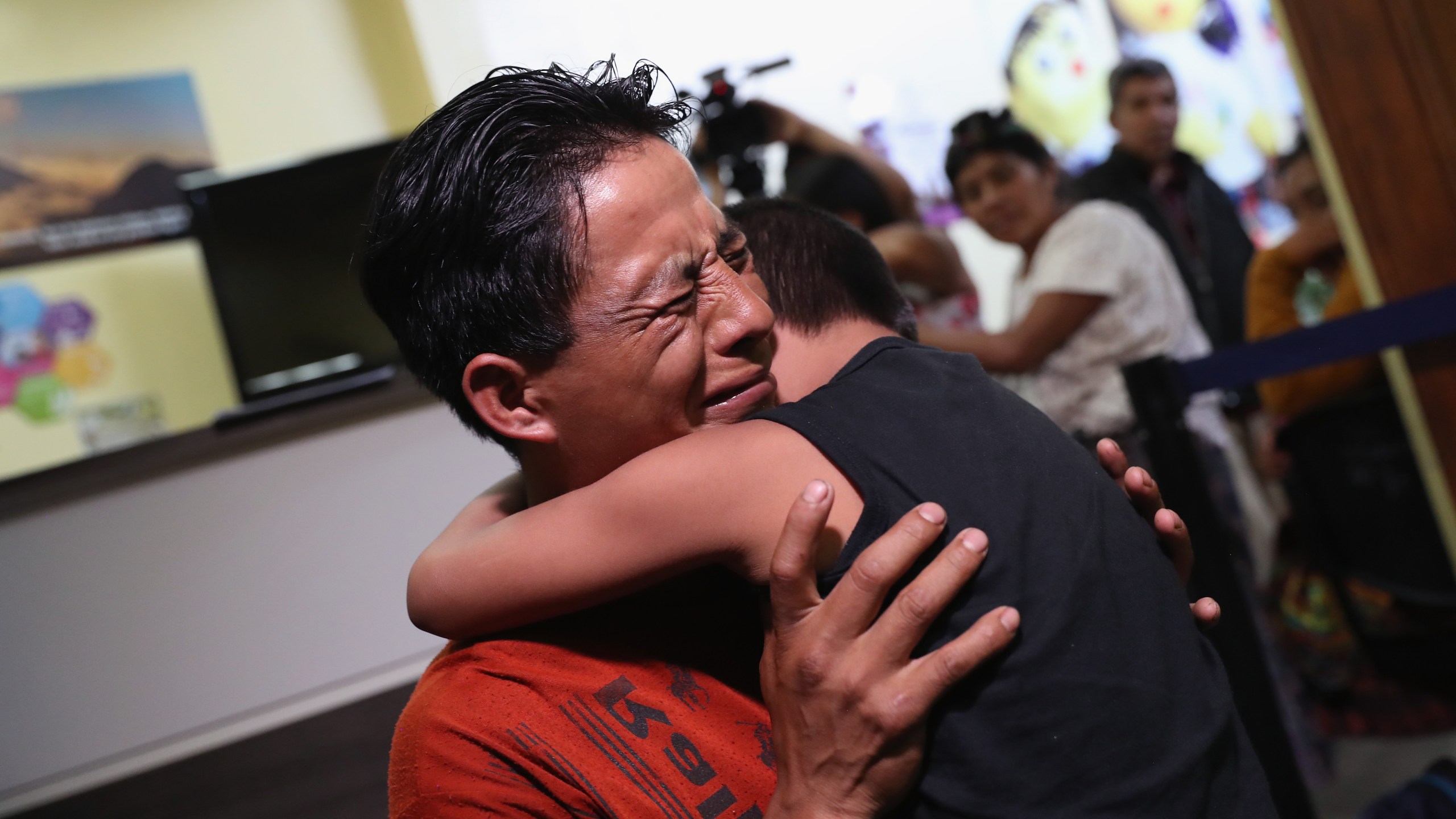 An emotional father embraces his son for the first time in months on Aug. 7, 2018, in Guatemala City, Guatemala. (Credit: John Moore / Getty Images)